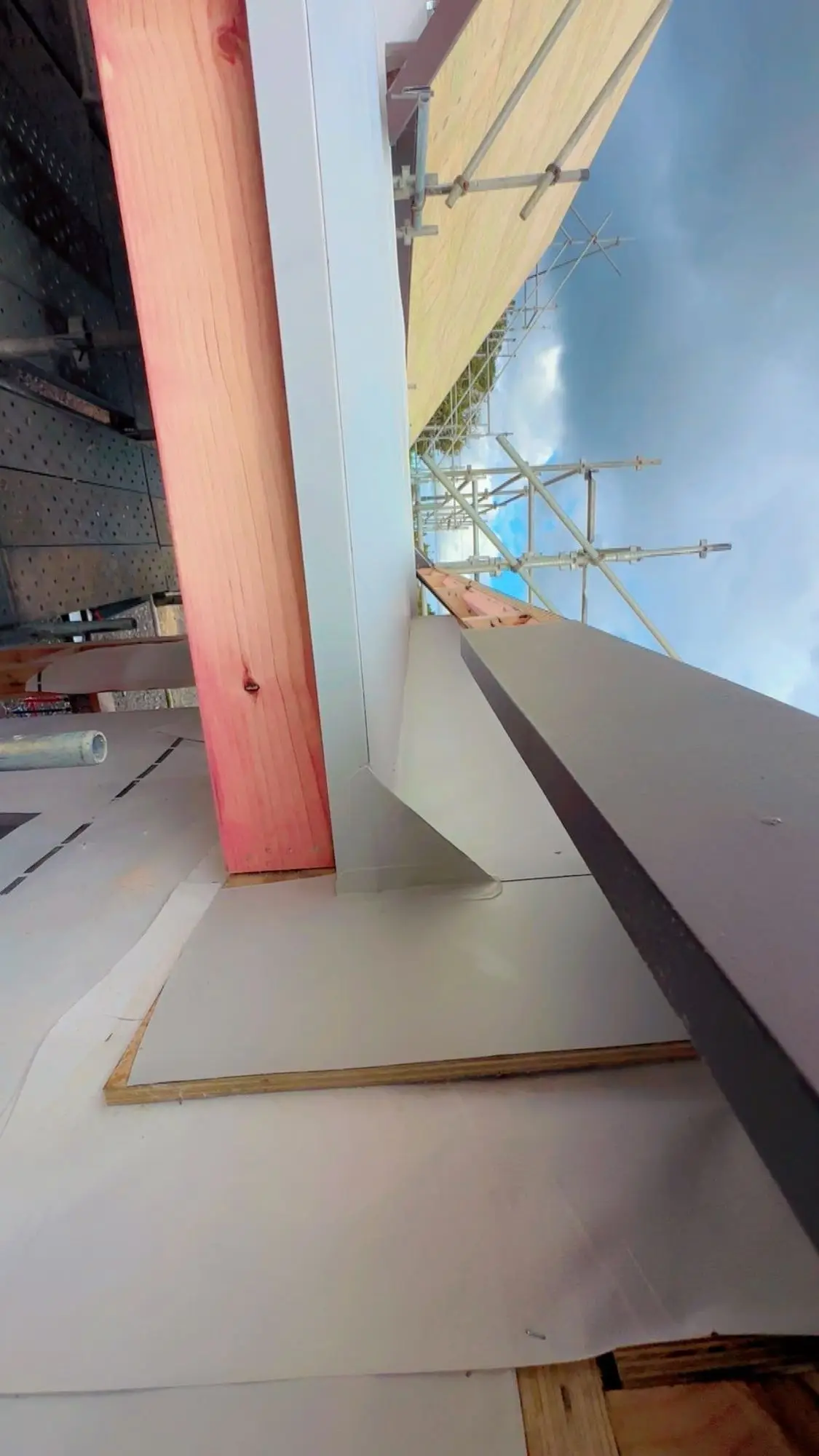 Apron and saddle flashing dressed against timber framing