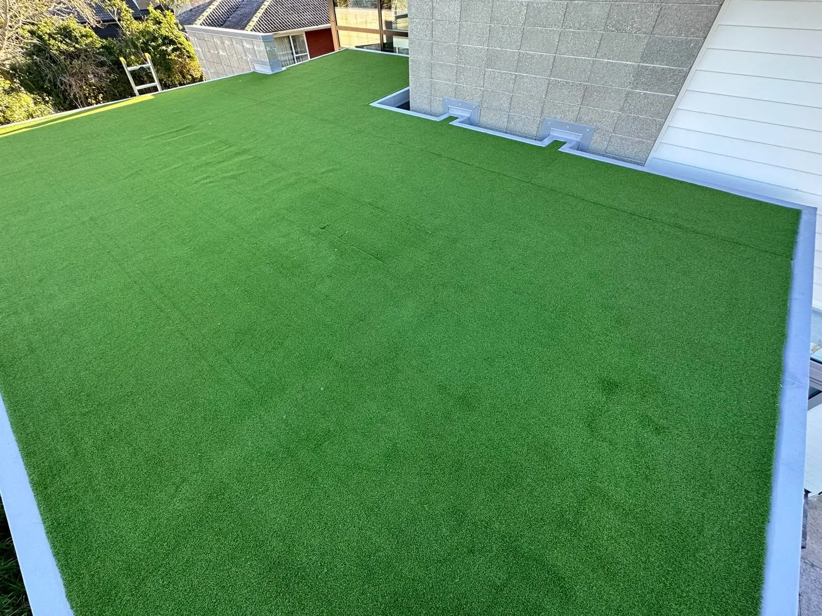 Artificial turf laid over a waterproof membrane deck in Auckland