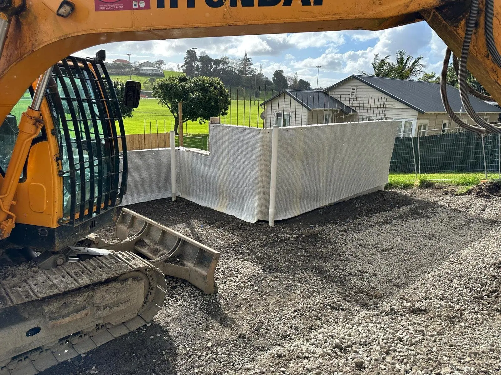 Below ground tanking membrane applied to a retaining wall before backfill