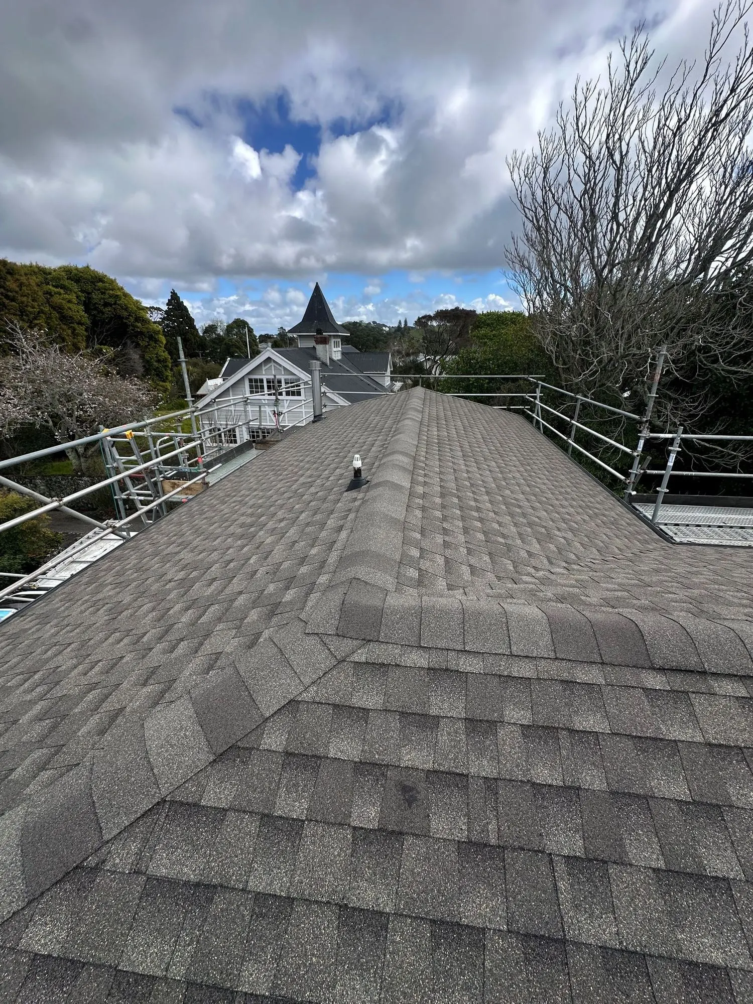 Completed asphalt shingle roof ridge on an Auckland property
