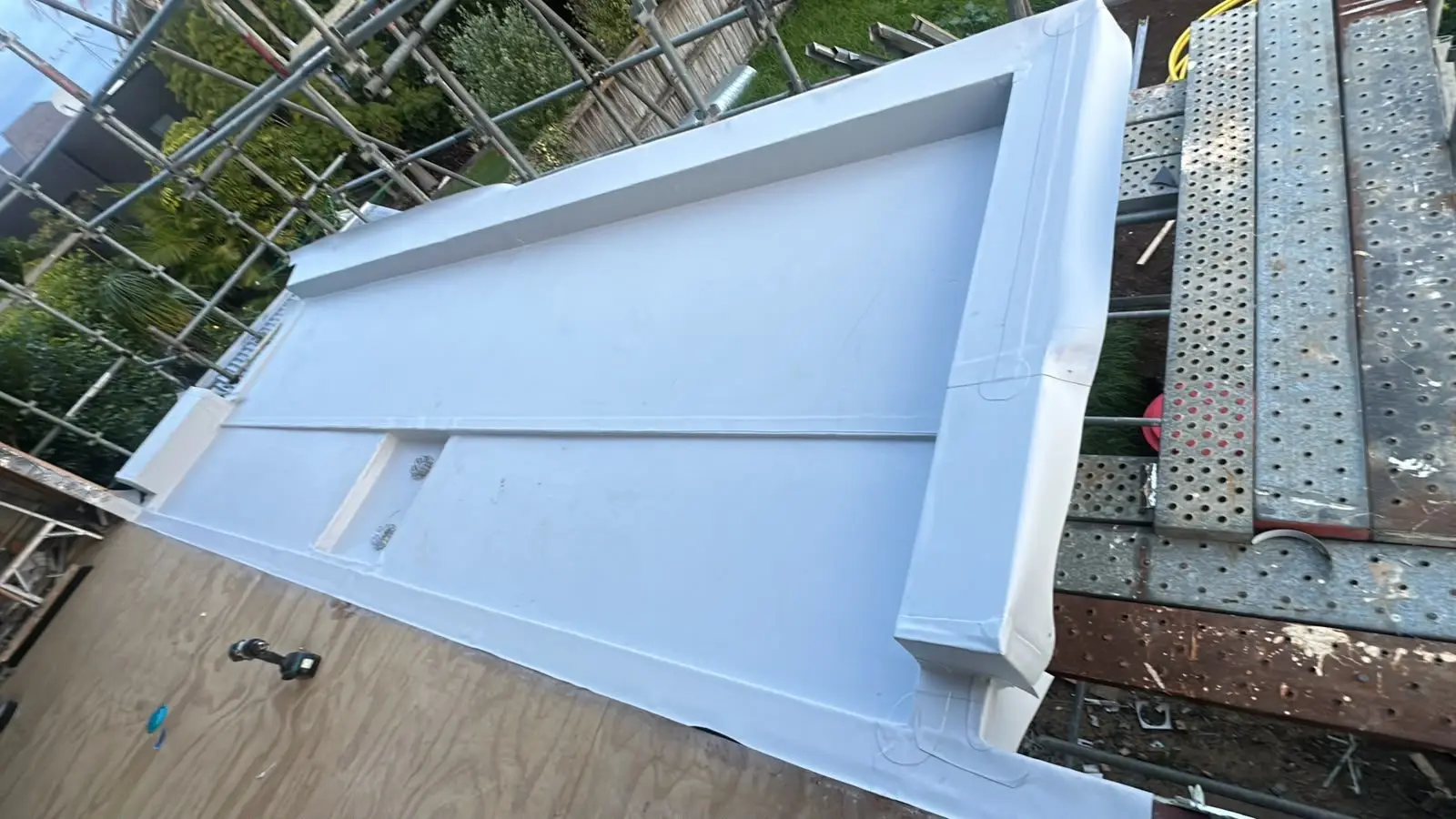 Custom folded ridge cap being installed on a tile roof
