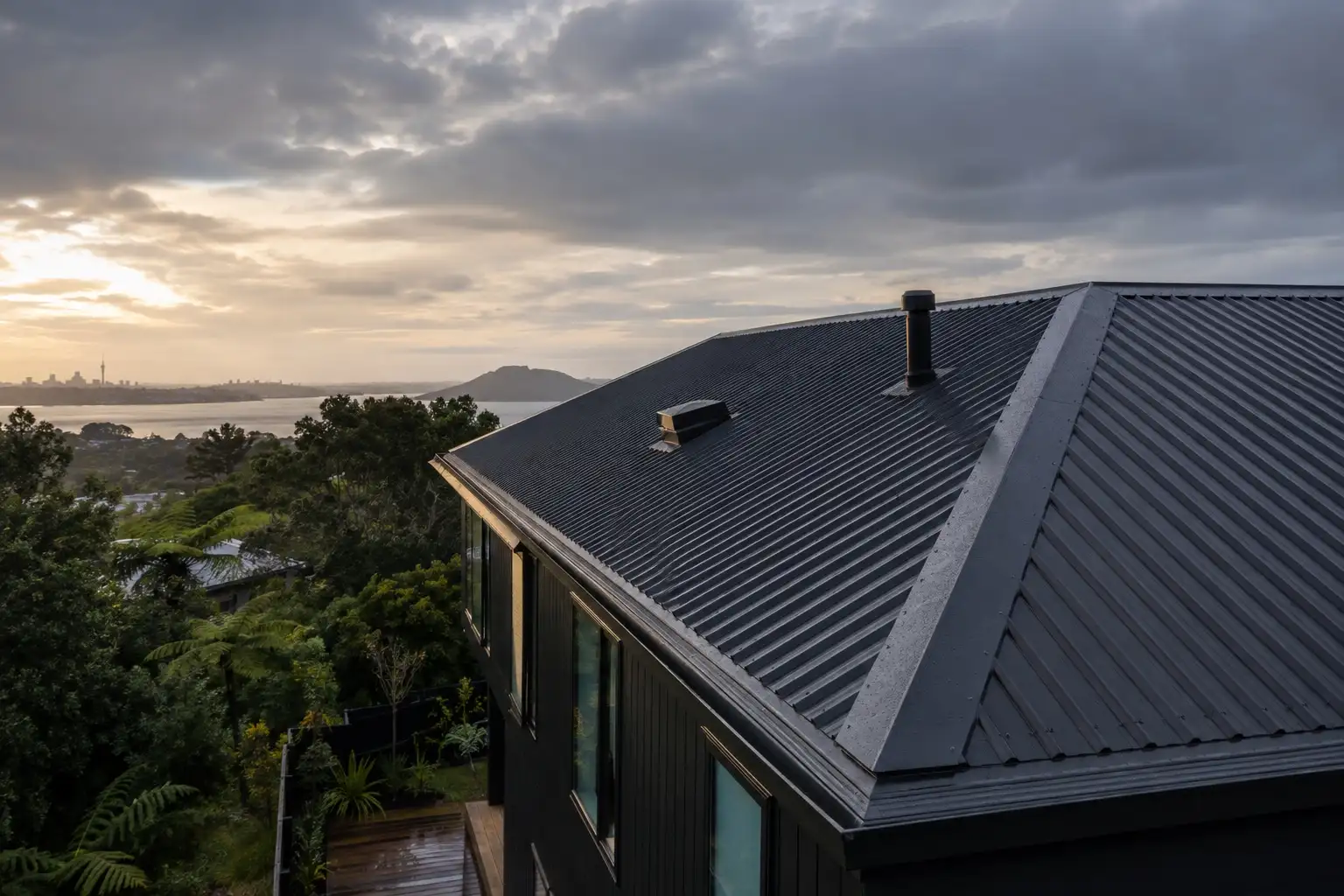 Completed charcoal long-run metal roof on an Auckland home