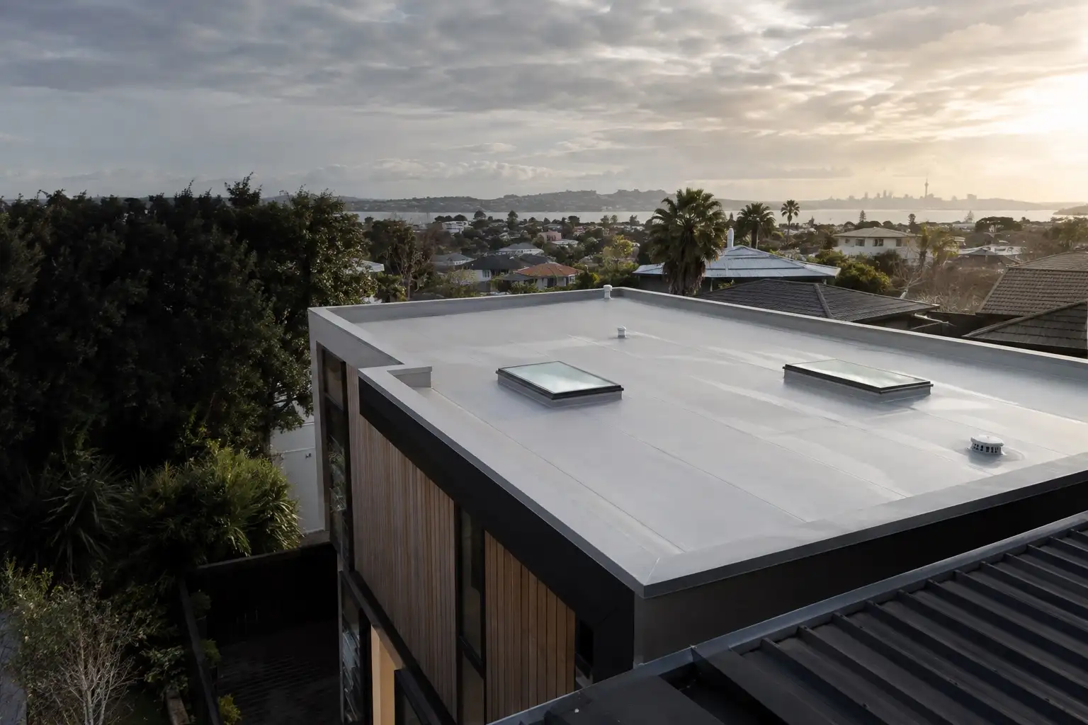 Completed light grey membrane roof on a modern Auckland home