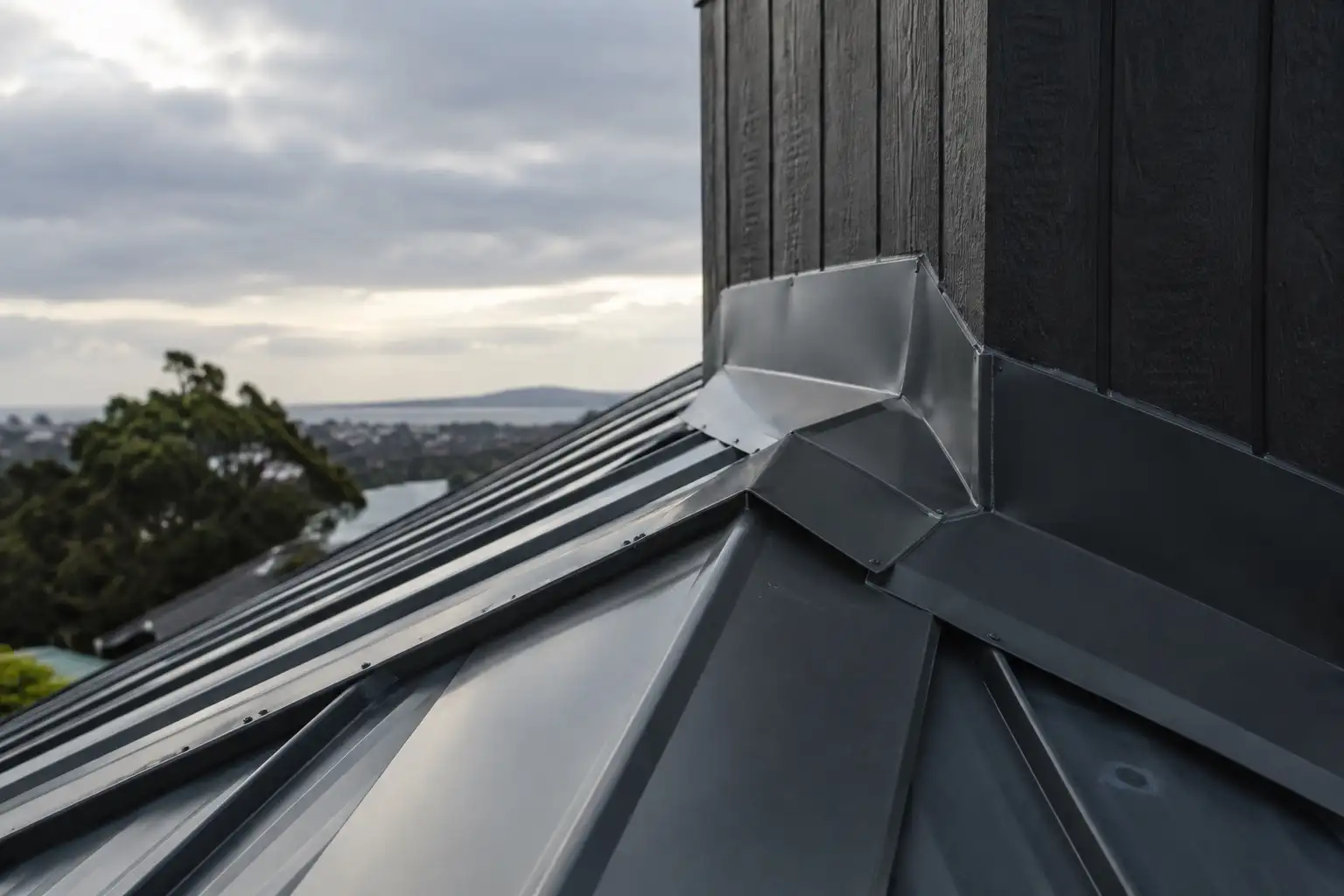 Finished saddle flashing where a metal roof meets a vertical wall