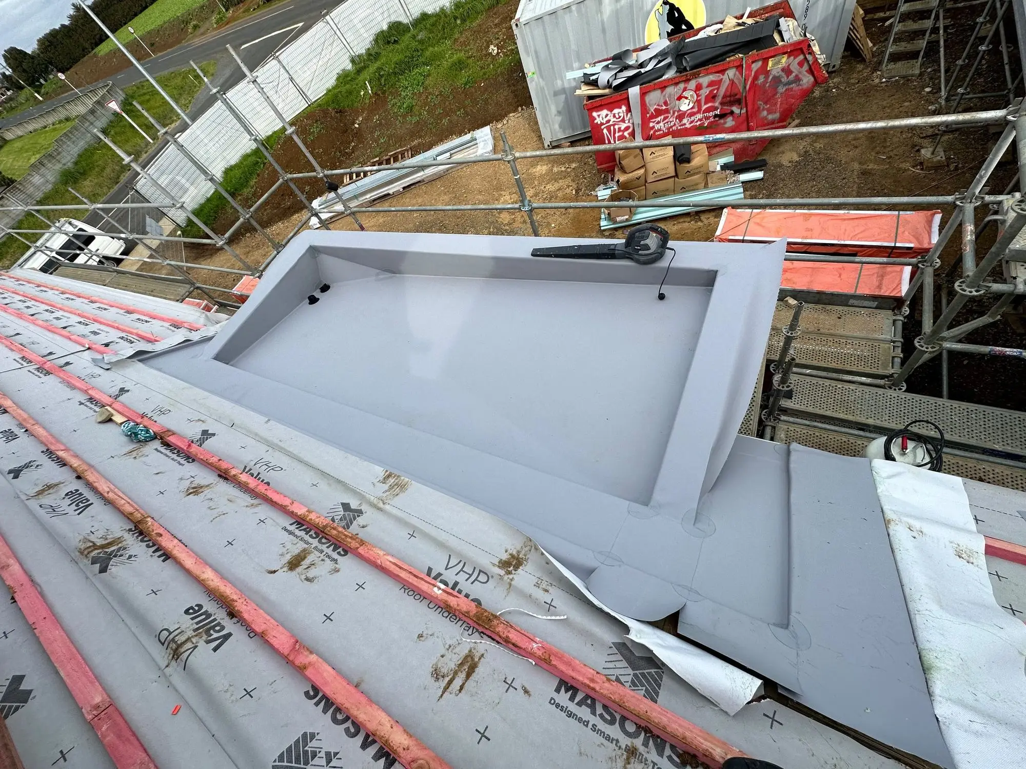 Membrane-lined structure under construction before backfill
