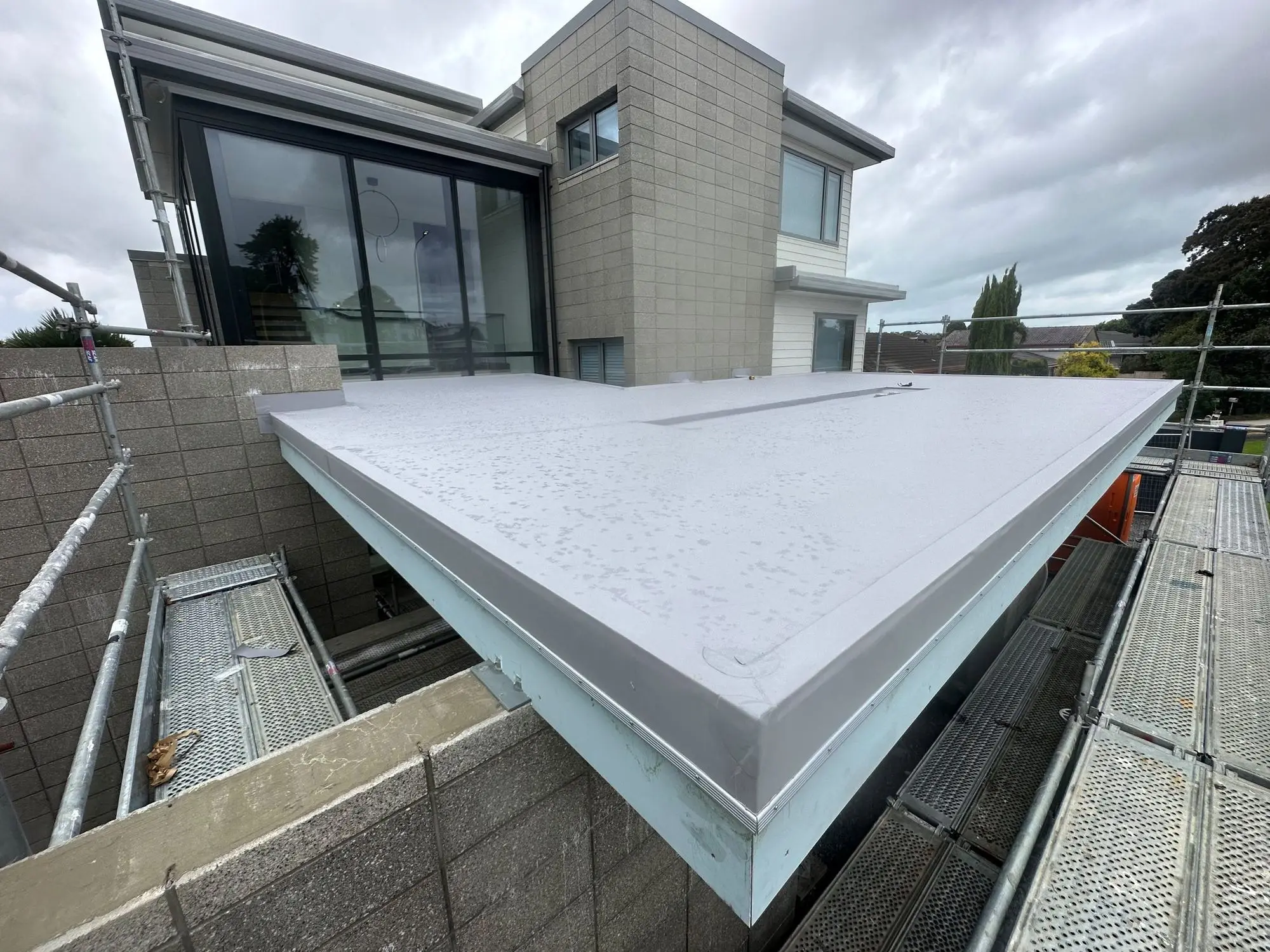TPO membrane parapet corner cap detail on an Auckland build