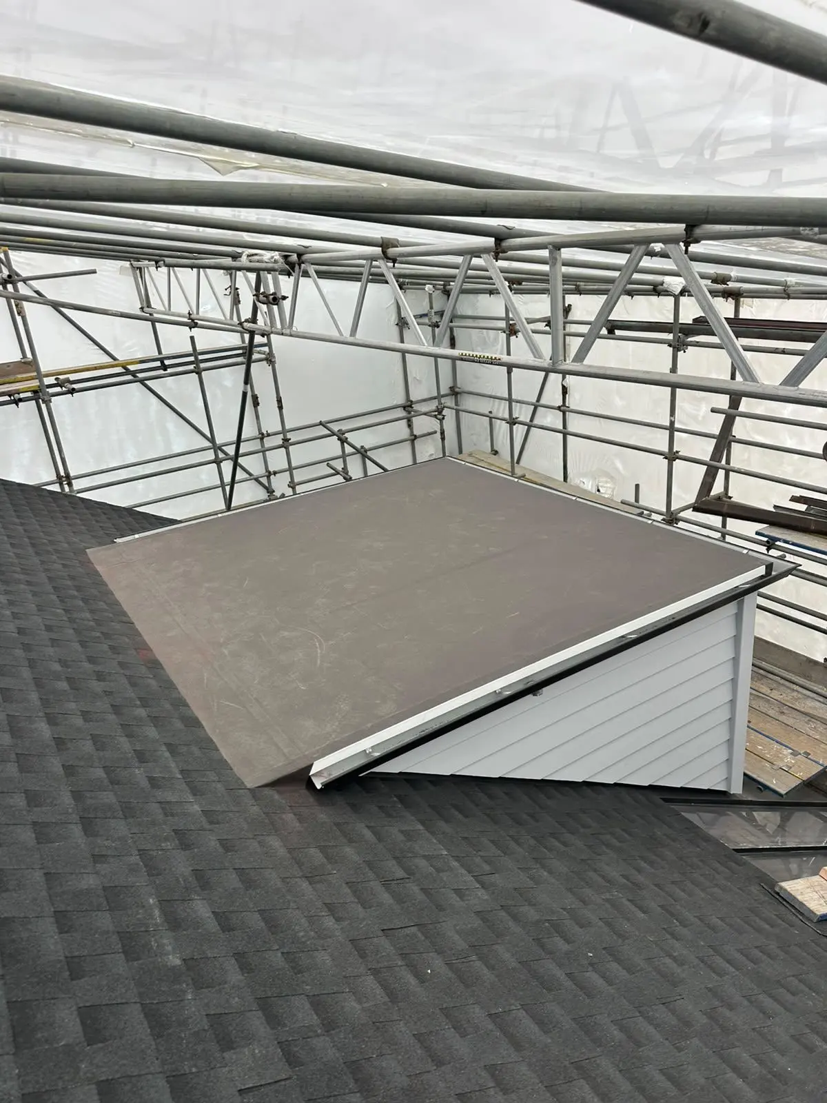 Flat dormer flashed into an asphalt shingle roof