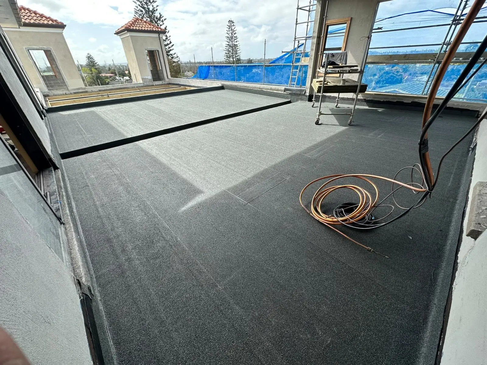 New torch-on membrane roof with skylights replacing failed butynol