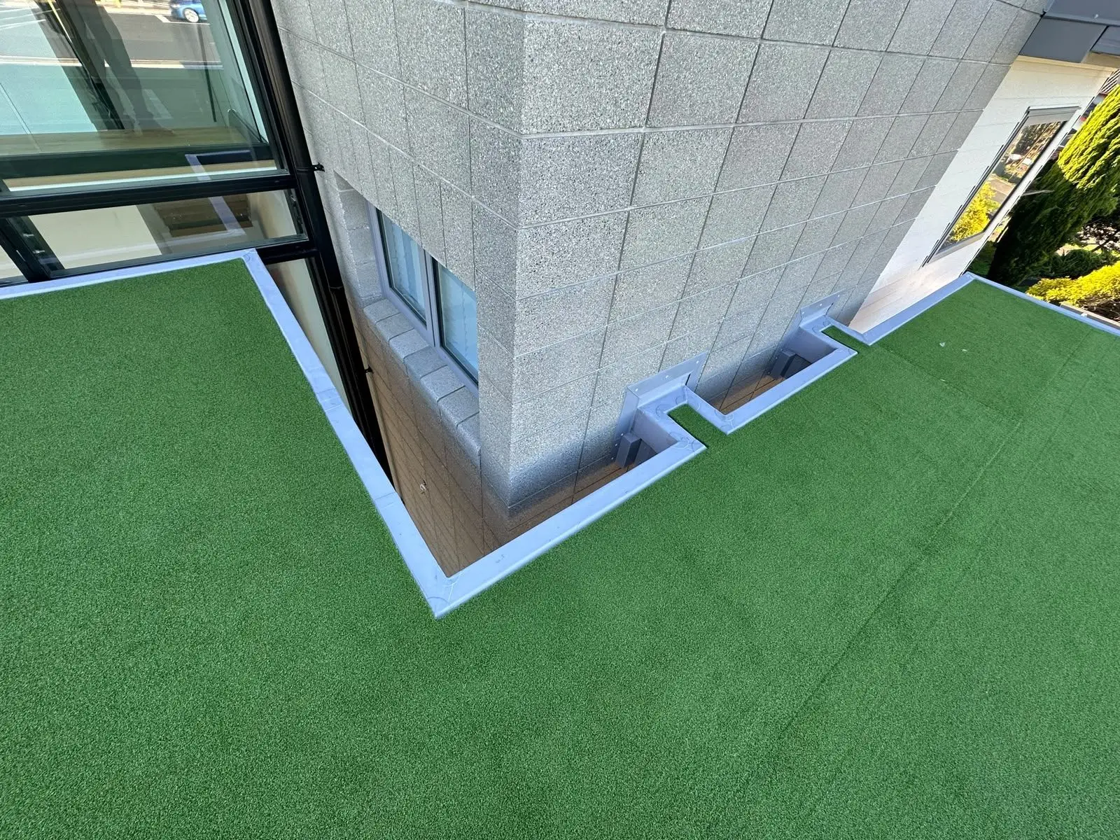 TPO membrane upstand detail where a turf deck meets a block wall
