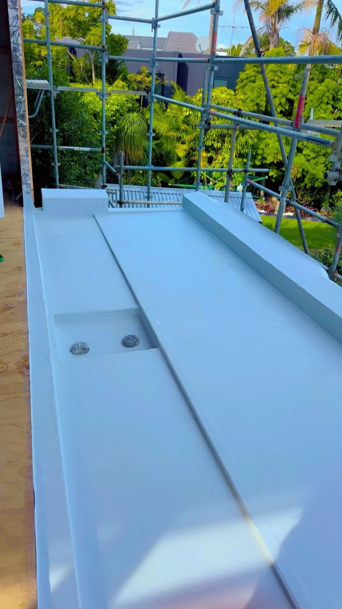 Hot-air welded membrane internal gutter running the length of a roof